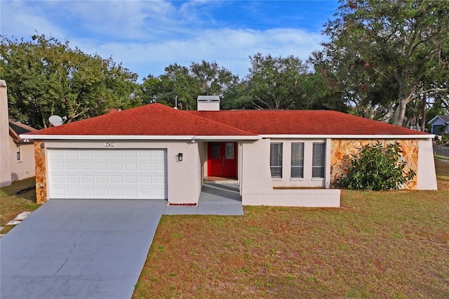 single story home featuring a garage and a front yard