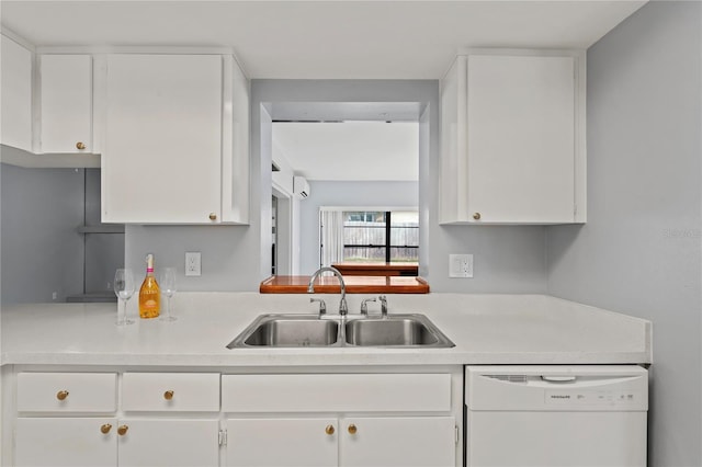 kitchen with white cabinetry, dishwasher, and sink