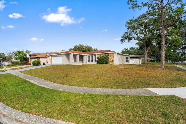 view of front of house with a front yard and a garage