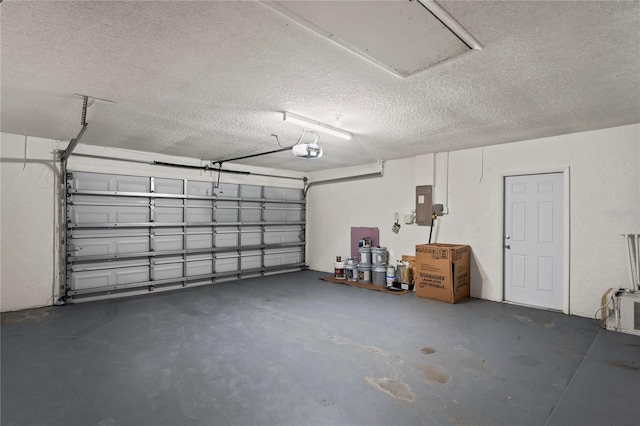 garage featuring electric panel and a garage door opener