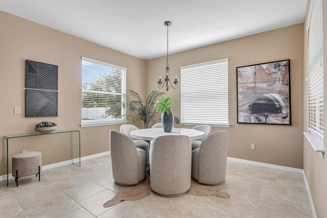 tiled dining space featuring a notable chandelier