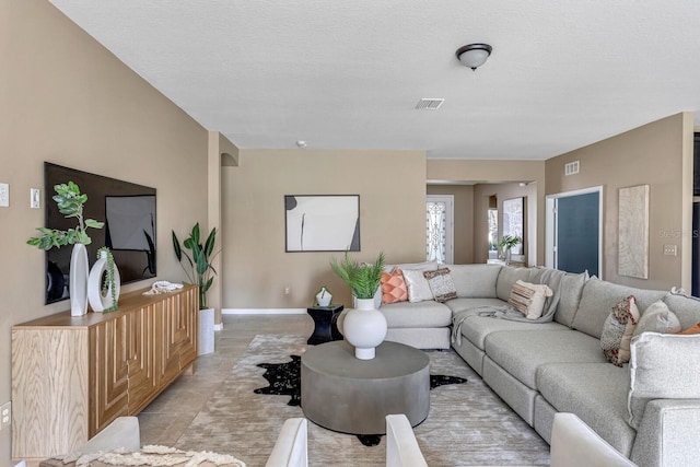 tiled living room with a textured ceiling