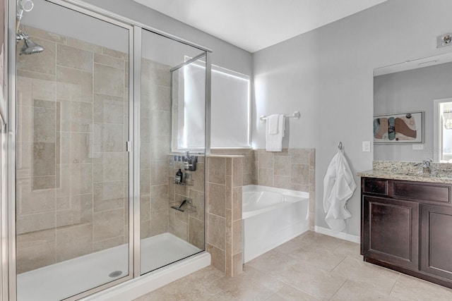 bathroom featuring tile patterned flooring, vanity, a wealth of natural light, and independent shower and bath