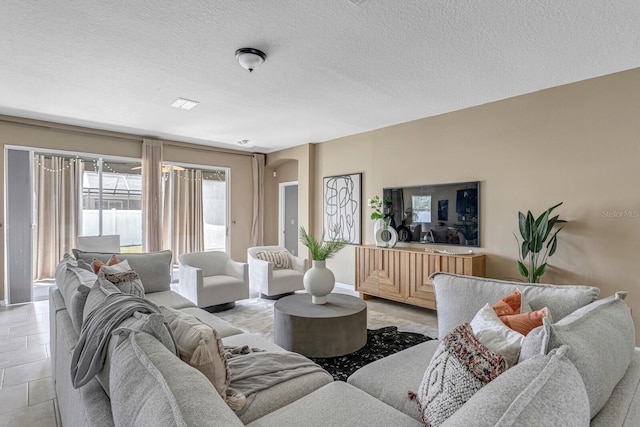 living room with light tile patterned floors and a textured ceiling