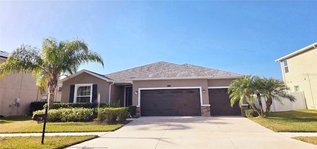 view of front of house featuring a front yard and a garage