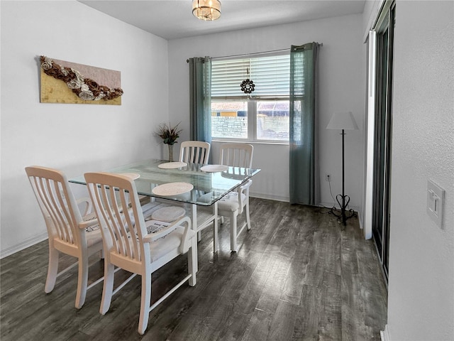 dining room with dark hardwood / wood-style flooring