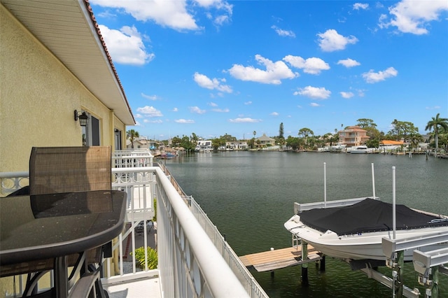 balcony with a dock and a water view