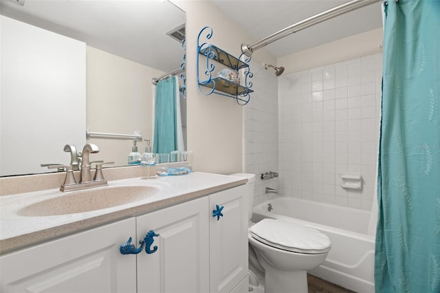 full bathroom featuring vanity, shower / tub combo, and toilet