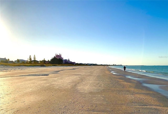 view of street with a water view and a beach view