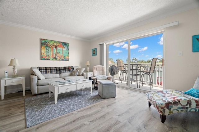 living room featuring ornamental molding, a textured ceiling, and hardwood / wood-style flooring