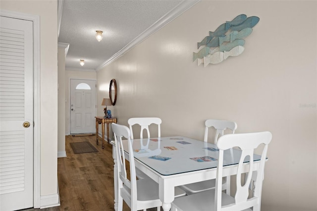 dining space featuring ornamental molding, a textured ceiling, and dark hardwood / wood-style floors