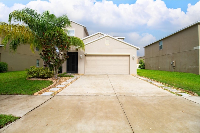 view of front of property featuring a front yard and a garage