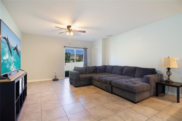 living room with ceiling fan and light tile patterned flooring