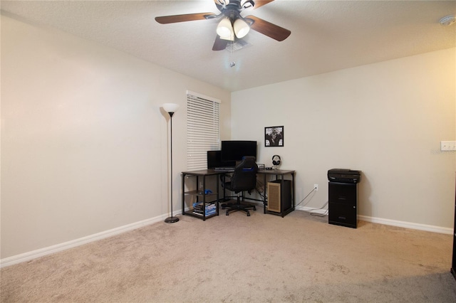 carpeted home office featuring ceiling fan