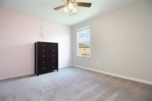 unfurnished bedroom with ceiling fan and light colored carpet