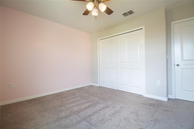 unfurnished bedroom featuring ceiling fan, a closet, and light carpet