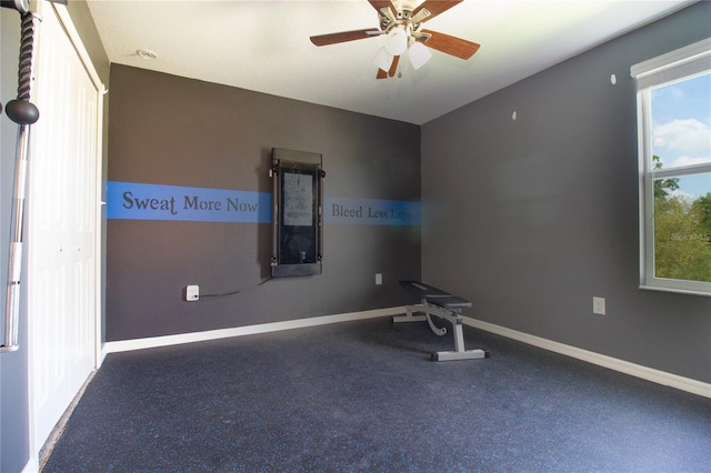 workout room with ceiling fan and carpet floors