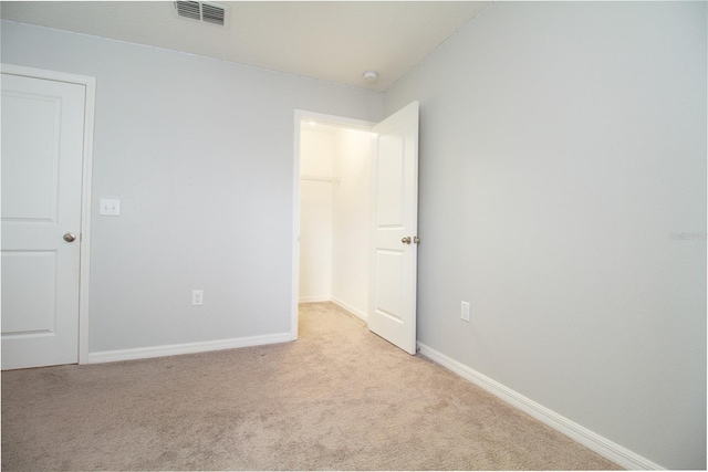 empty room featuring light colored carpet