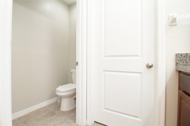 bathroom featuring tile patterned flooring and toilet