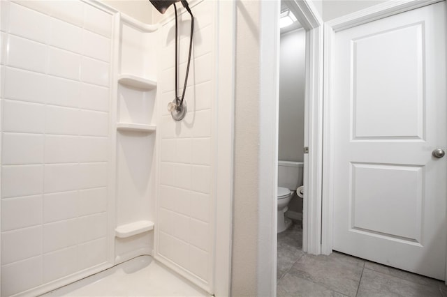 bathroom with toilet, tile patterned flooring, and walk in shower