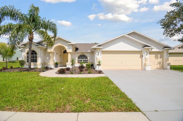 view of front of home with a front yard and a garage