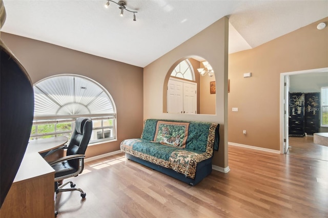 home office featuring lofted ceiling and light hardwood / wood-style floors