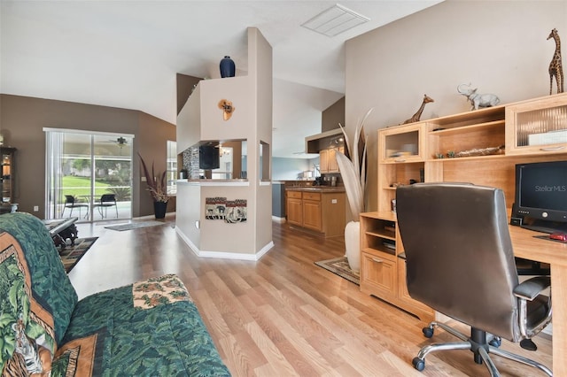 office space featuring vaulted ceiling and light wood-type flooring