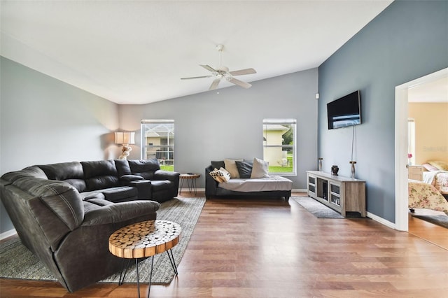 living room featuring hardwood / wood-style flooring, ceiling fan, and lofted ceiling