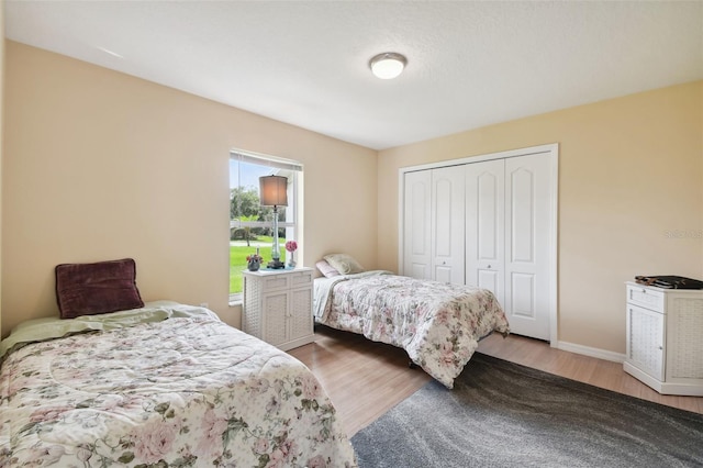 bedroom featuring hardwood / wood-style floors and a closet