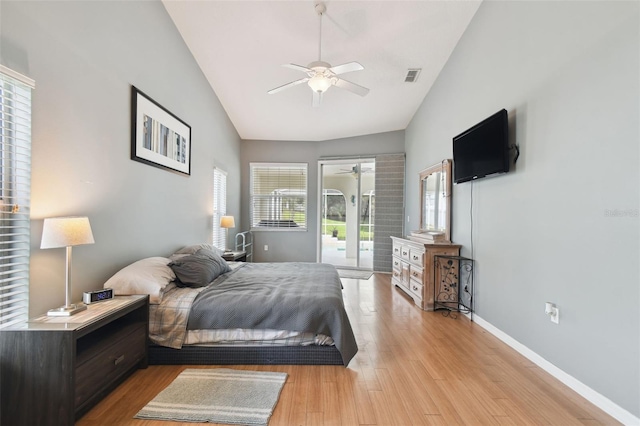 bedroom with ceiling fan, access to exterior, high vaulted ceiling, and light hardwood / wood-style flooring