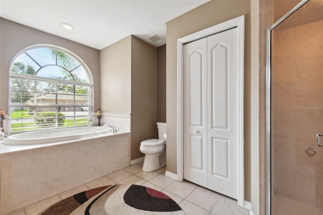 bathroom with independent shower and bath, tile patterned flooring, and toilet