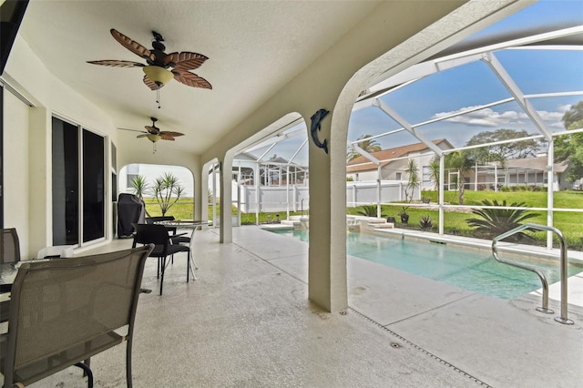 view of pool with ceiling fan, a lanai, and a patio