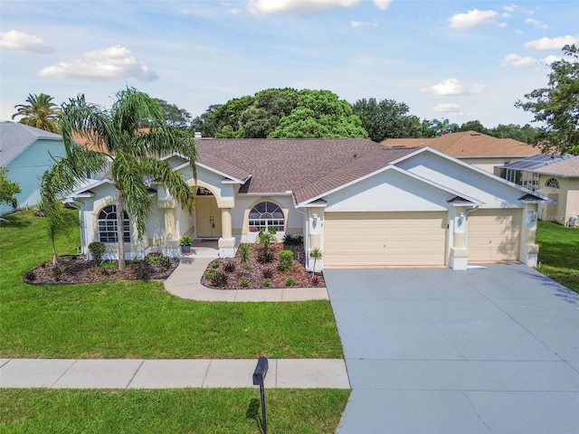 view of front of home with a garage and a front lawn