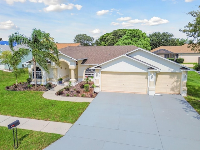 view of front of home featuring a garage and a front yard