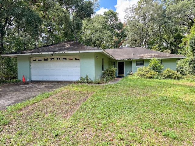 ranch-style house with a front yard and a garage