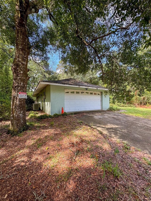 view of side of home featuring a garage