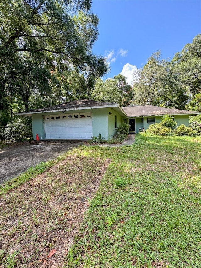 ranch-style house with a front lawn and a garage