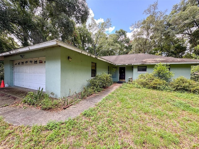 single story home with a front lawn and a garage