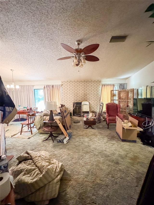 carpeted living room with ceiling fan with notable chandelier and a textured ceiling