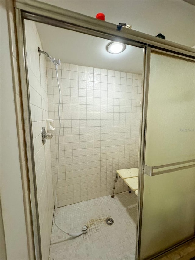 bathroom with a shower with shower door