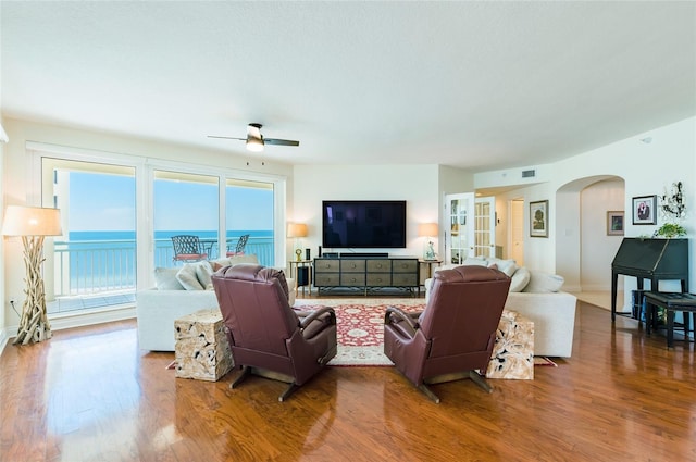 living room with ceiling fan and hardwood / wood-style flooring