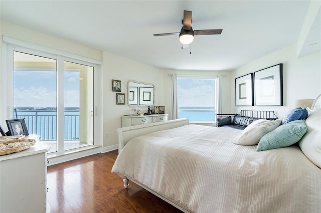 bedroom with ceiling fan, a water view, hardwood / wood-style flooring, and access to exterior