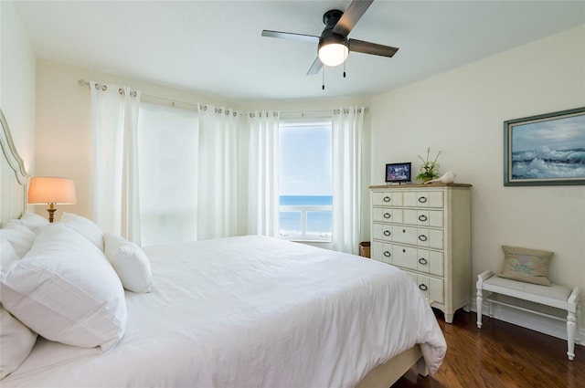 bedroom with ceiling fan and dark hardwood / wood-style floors