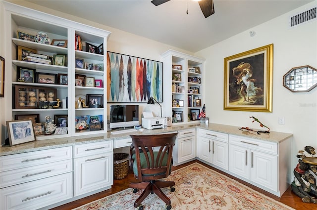 office space with ceiling fan, light wood-type flooring, and built in desk