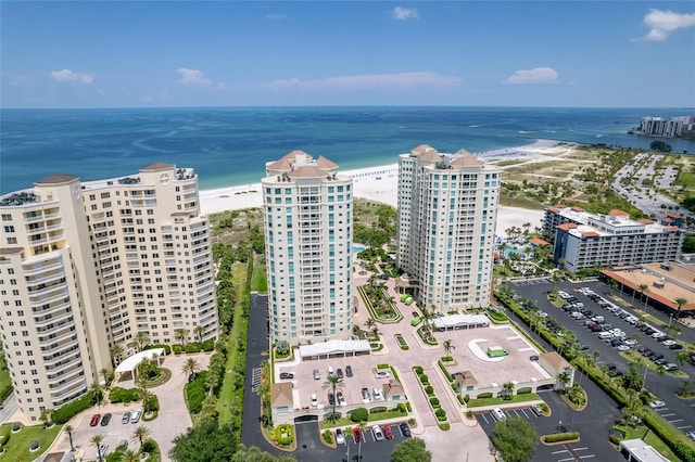 drone / aerial view with a beach view and a water view