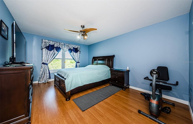 bedroom featuring wood-type flooring and ceiling fan