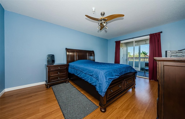 bedroom featuring hardwood / wood-style flooring, ceiling fan, access to outside, and a textured ceiling