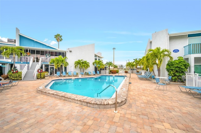 view of swimming pool featuring central AC and a patio