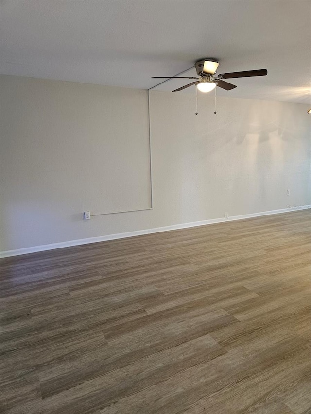 empty room with ceiling fan and hardwood / wood-style floors