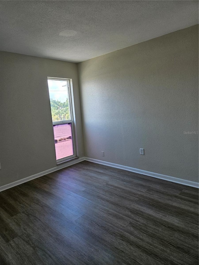 unfurnished room with a textured ceiling and hardwood / wood-style flooring